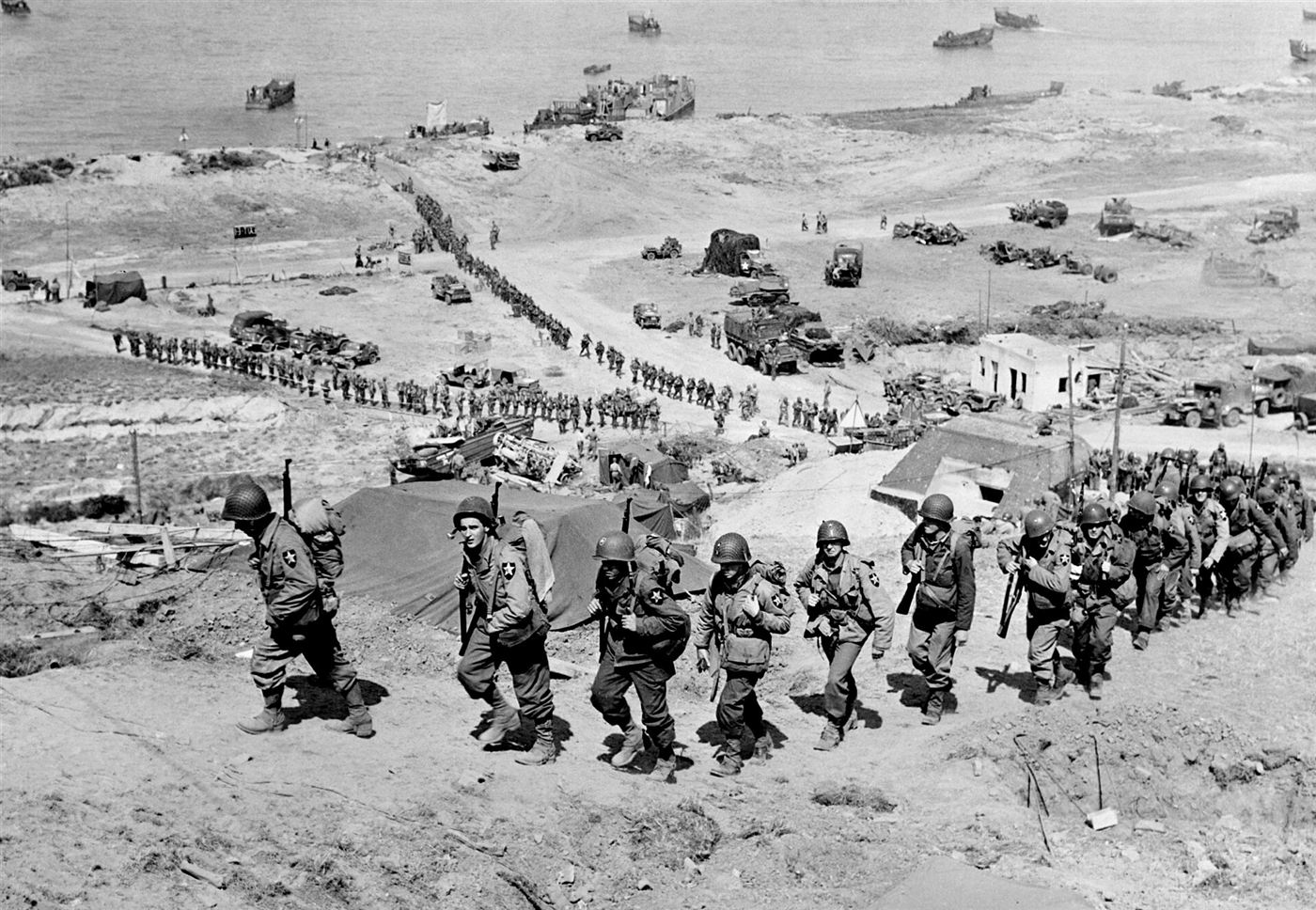 U.S. 2nd Infantry Division troops move up the E-1 draw at Omaha Beach, June 1944.