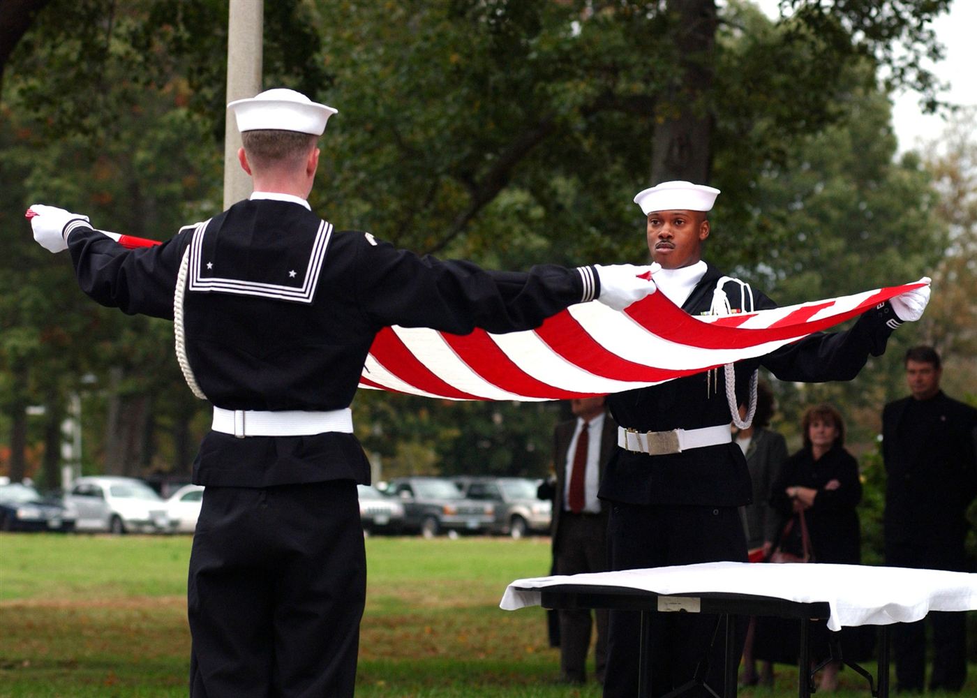 An honor guard folds the American flag for presentation to a family.