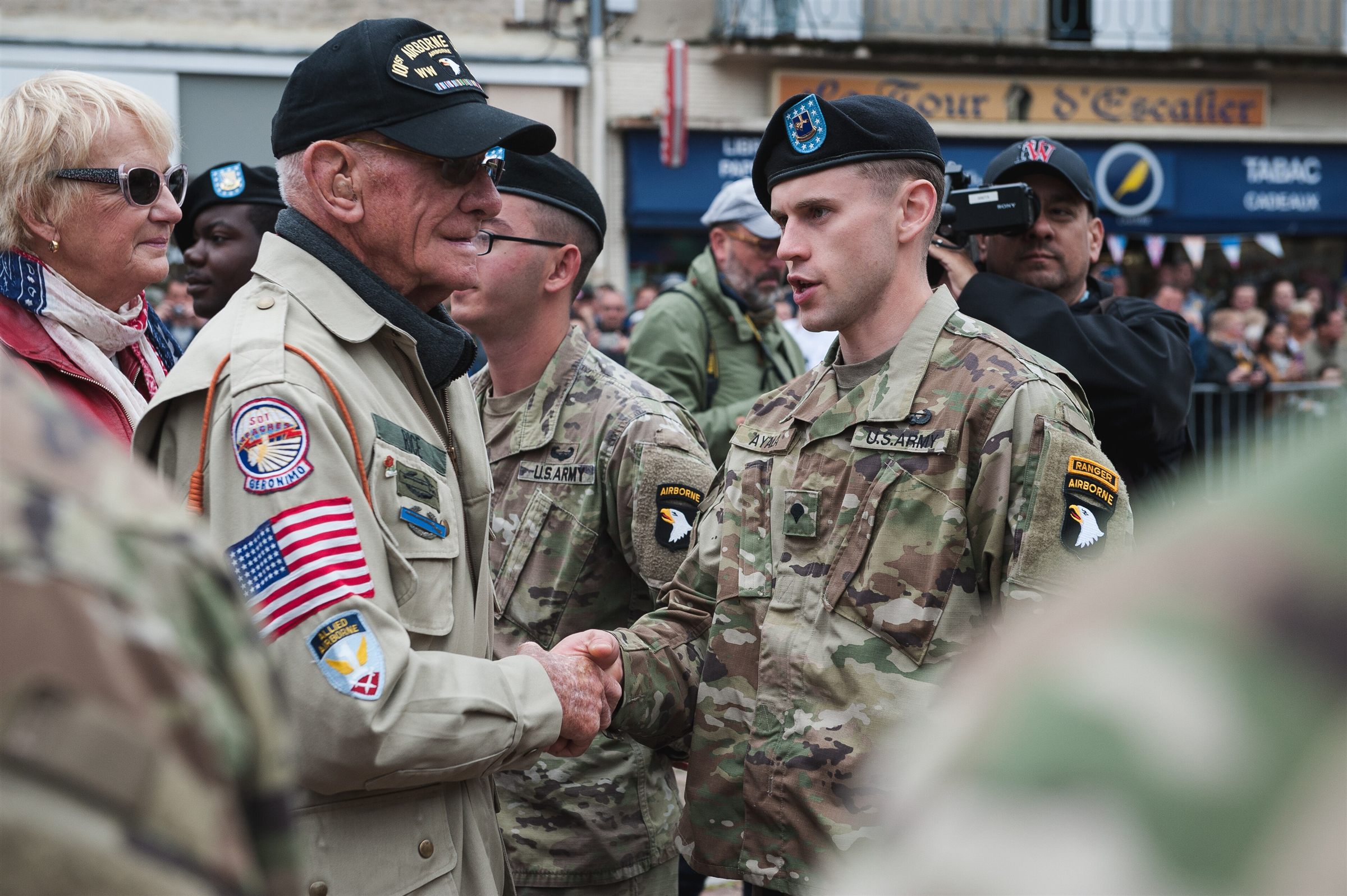 A World War II veteran greets soldiers of the 101st Airborne.